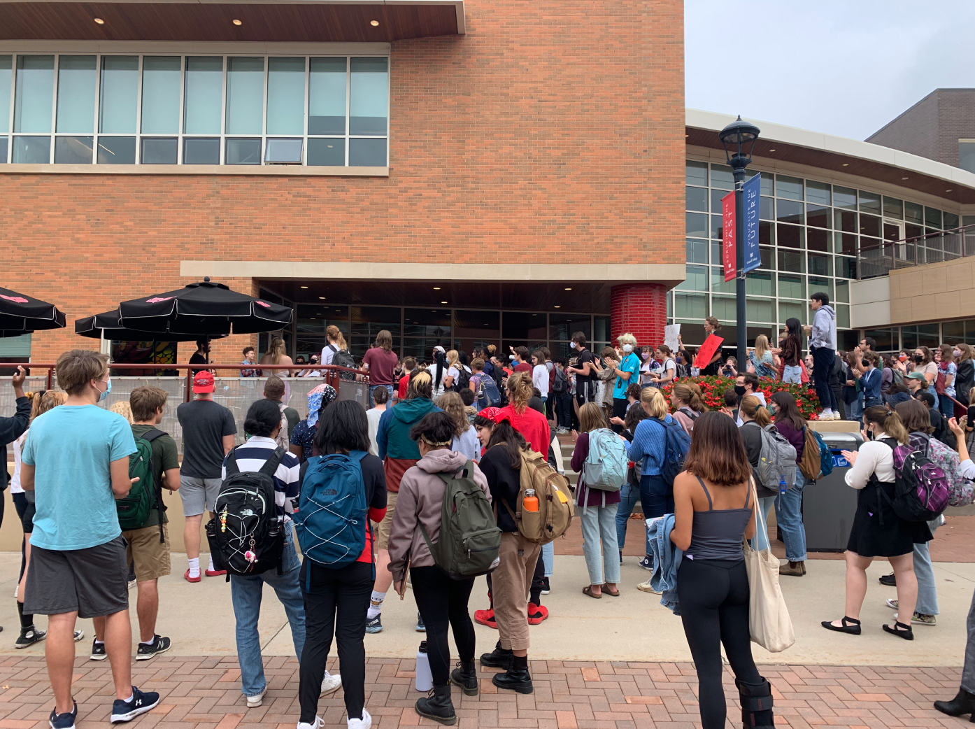 Hundreds of students and student-workers gather outside the Joe Rosenfield Center rallying in support of mailroom student workers